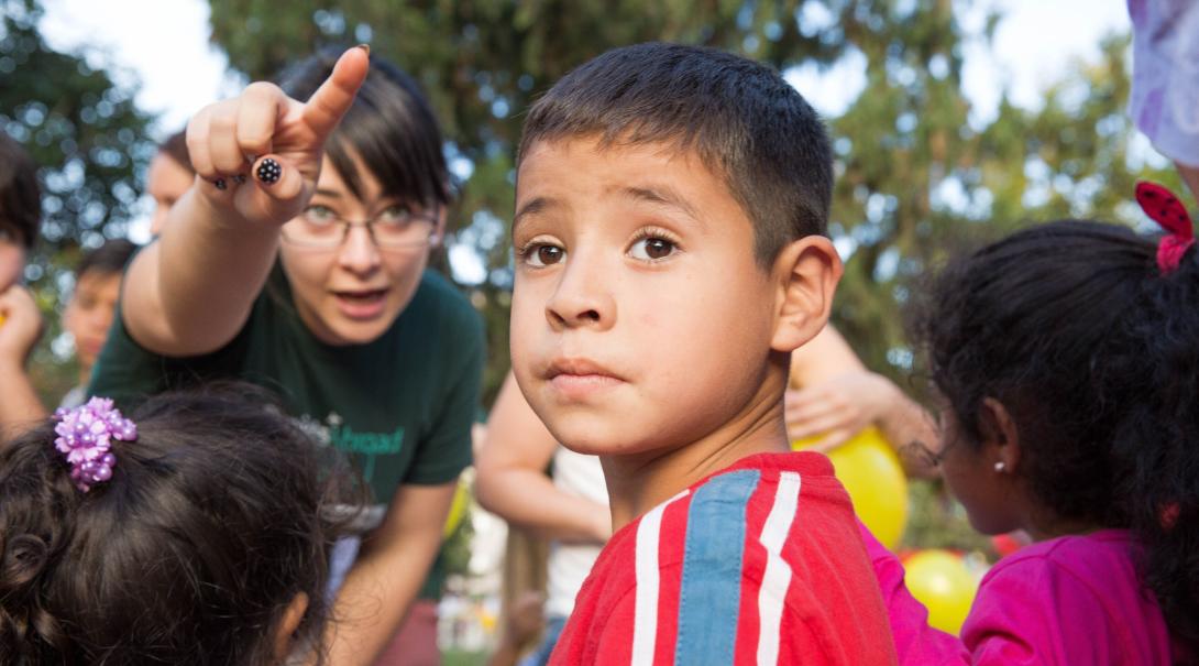 A project expert giving a local child instructions as part of a community outreach day in Argentina A Projects Abroad project expert telling a child where to go to participate in the community outreach day